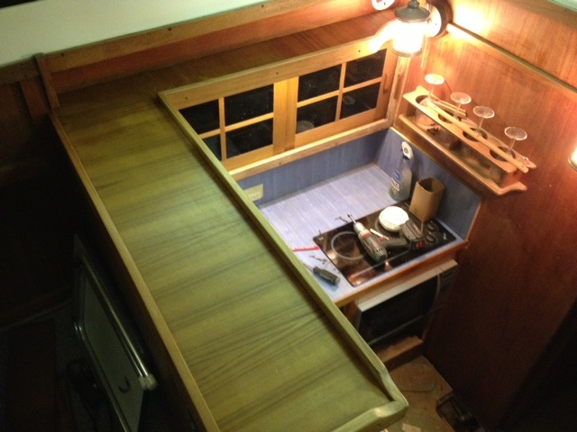 Upper counter with teak veneer, bad lighting, not true color